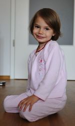 Portrait of smiling girl sitting at home