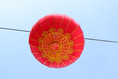 Low angle view of lantern against clear blue sky