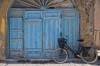 Bicycle against closed door of old building