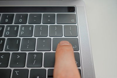 Cropped hand using laptop