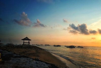 Scenic view of beach against sky during sunset