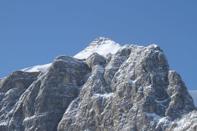 Low angle view of mountain against clear blue sky