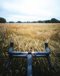 Bicycle on field against sky