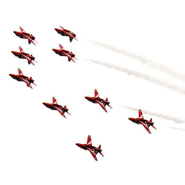 flying, mid-air, air vehicle, low angle view, airplane, red, transportation, clear sky, airshow, motion, mode of transport, copy space, teamwork, on the move, order, kite - toy, freedom, travel, fighter plane, day