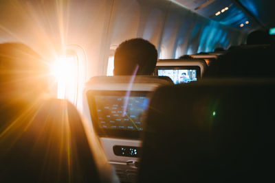 Rear view of man sitting in airplane