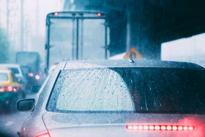 Close-up of car in traffic jam during rainy season