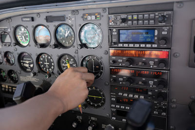 Cropped image of hand on airplane window