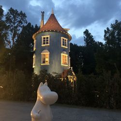 Sculpture of building by trees against sky