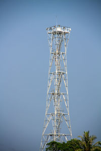 Low angle view of electricity pylon against clear sky