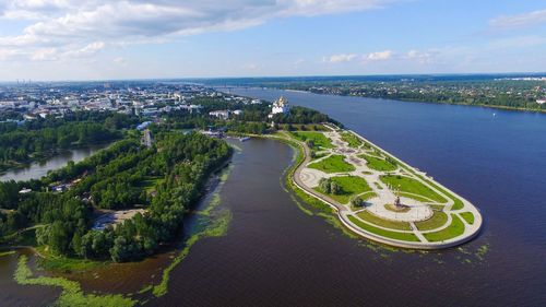 High angle view of city by sea against sky