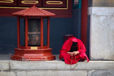 Full length of man on red outside building