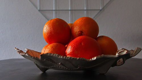 Close-up of fruits in basket on table