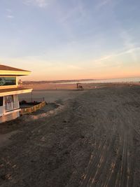 Scenic view of beach against sky during sunset