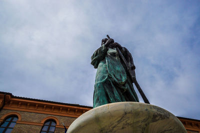 Low angle view of statue against sky