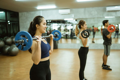 Side view of woman exercising in gym