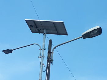 Low angle view of street light against clear blue sky