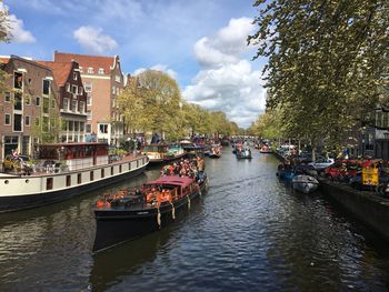 View of boats moored in canal in amsterdam