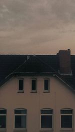 Low angle view of building against sky at sunset