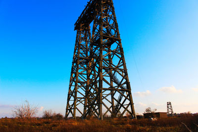 Low angle view of communications tower against sky