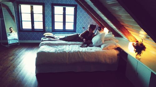 People relaxing on bed at home