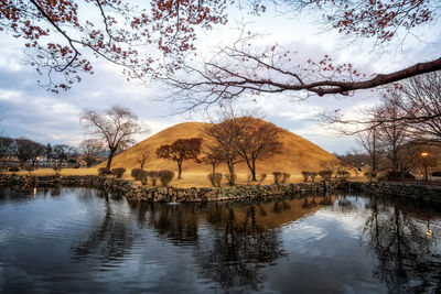 Royal mounds reflections on a small pond in daereungwon, gyeongju, south korea