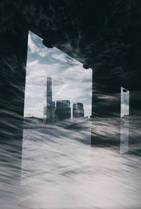 Digital composite image of modern buildings against sky