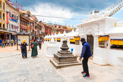 People walking in front of historical building