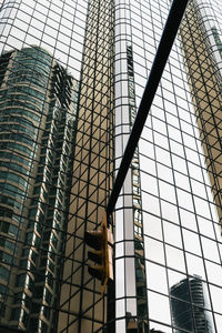 Low angle view of modern glass building in city