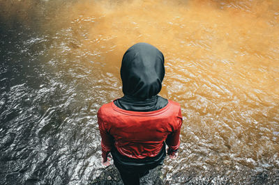 Rear view of girl standing in lake