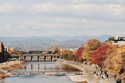 Bridge over river with city in background