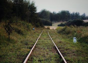 Railroad track on grassy field