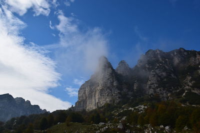 Low angle view of mountain against blue sky