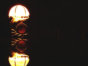 Low angle view of illuminated lamp at night