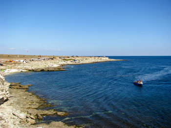 Scenic view of sea against clear blue sky