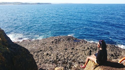 Low section of woman relaxing on beach