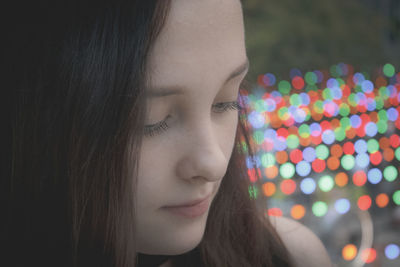 Close-up of woman with illuminated hair at night