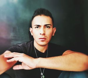 Close-up portrait of young man against wall