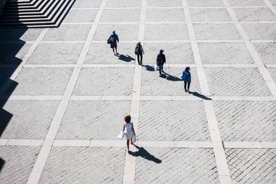 High angle view of people on walkway during sunny day