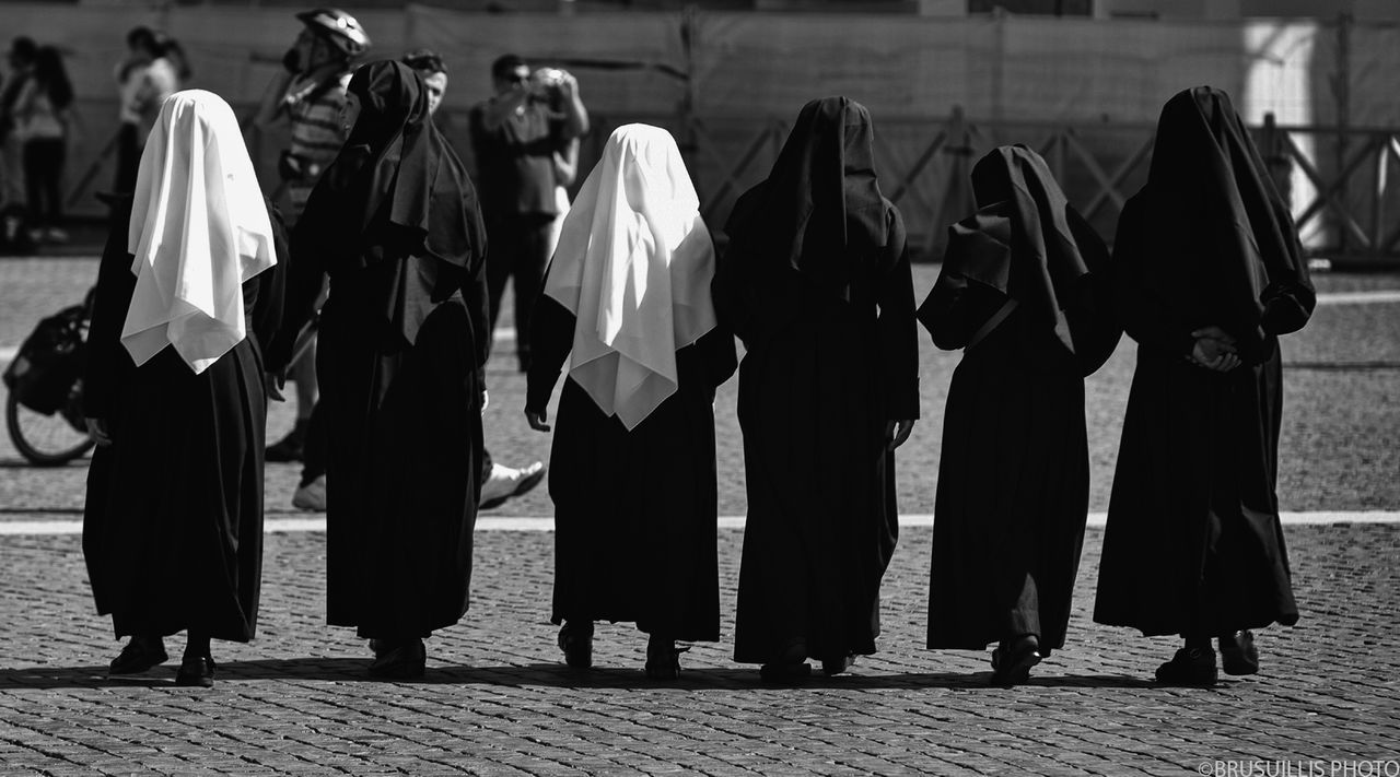 GROUP OF PEOPLE STANDING ON CROSS