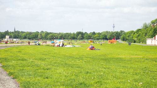 People on field against sky