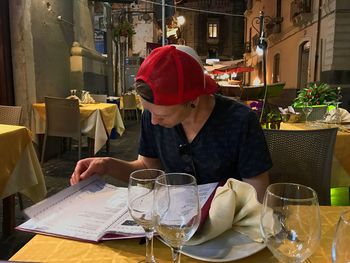 Midsection of woman sitting at restaurant table