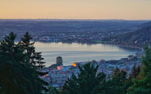 High angle view of townscape by sea against sky