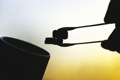 Low angle view of silhouette man against clear sky