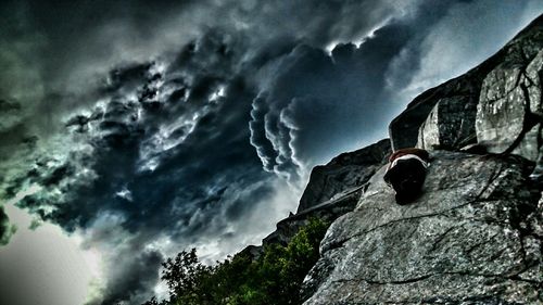 Low angle view of mountain against cloudy sky