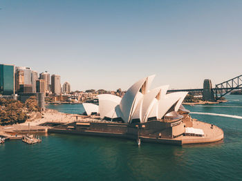 Panoramic view of boats in city against clear sky