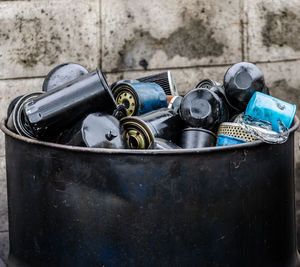 Close-up of garbage bin against wall