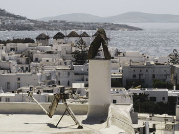 High angle view of townscape against sky - windmills of mykonos - view from above