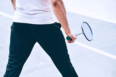 Midsection of man playing with ball