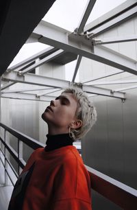 Portrait of man standing by railing