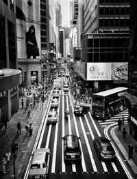 High angle view of vehicles on road along buildings